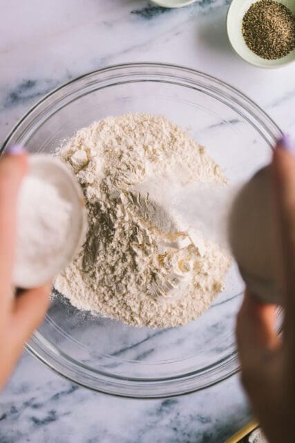 adding salt into flour for buttermilk biscuit dough