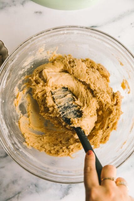 combining ingredients together with a rubber spatula for blondie recipe