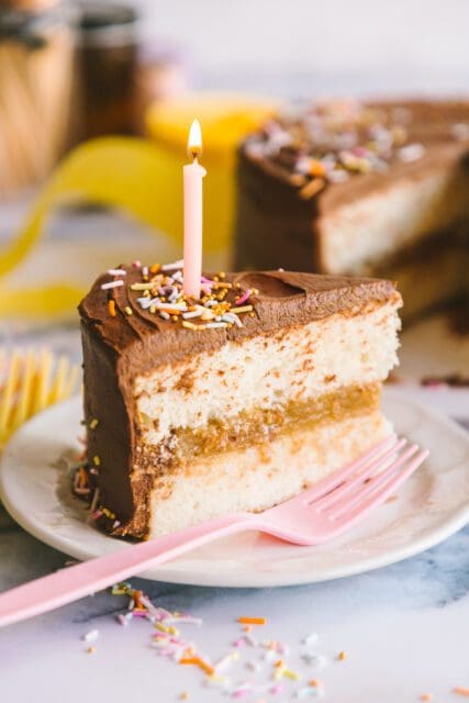 close up shot of birthday cake recipes with a lit candle on top