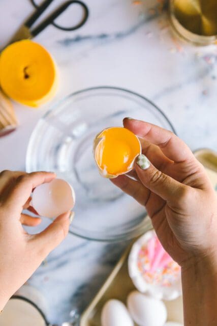 separating egg yolks to add to birthday cake recipes