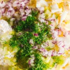 adding chopped fine herbs to the egg salad recipe