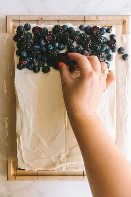 adding blueberries on the 4th of July cake