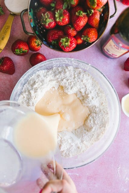 adding wet ingredients to dry for strawberry shortcake recipe