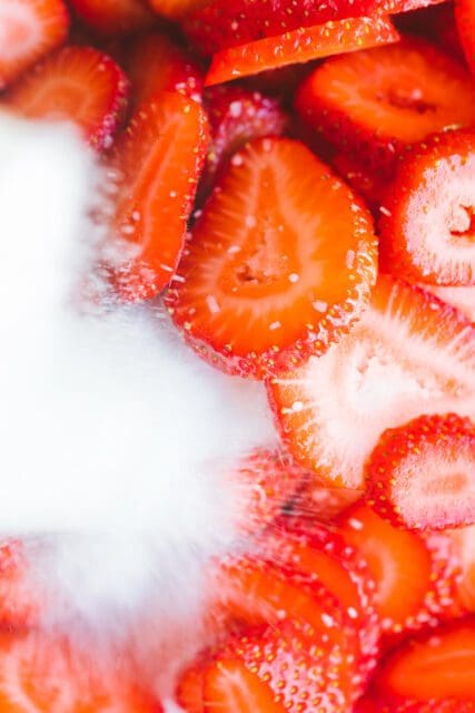 maserating strawberries in sugar