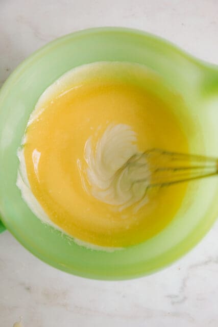 whisking melted butter into sour cream for kolaches