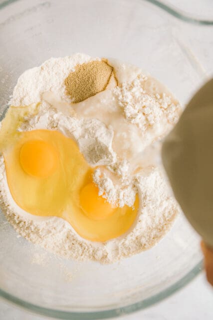 adding eggs to flour for kolache recipe