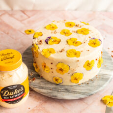 finished hummingbird cake with pressed edible flowers and the secret ingredient, Duke's Mayo