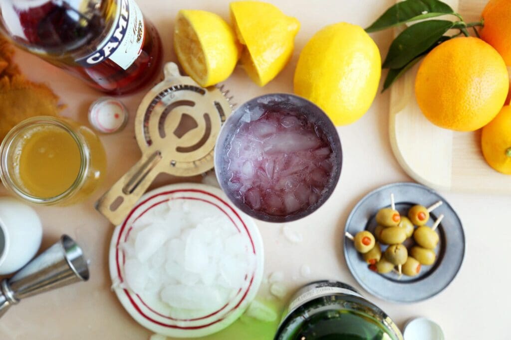 Gin sour ingredients with ice in a shaker.