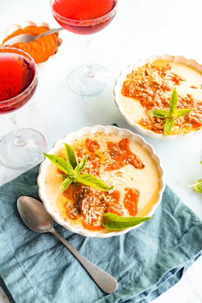 finished baked polenta recipe with tomatoes and basil on top