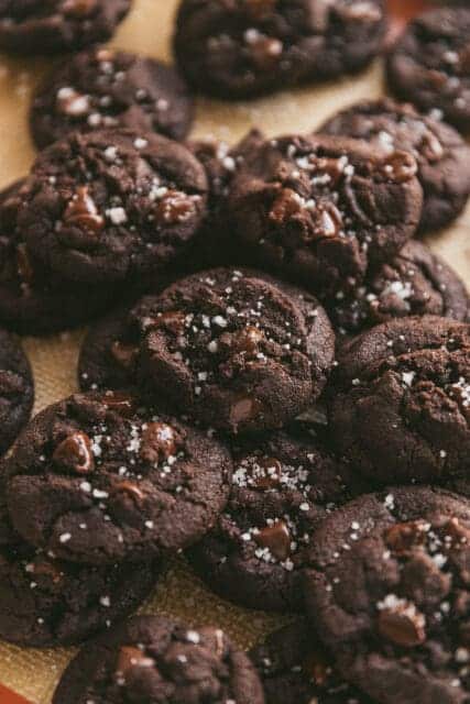 a bunch of double chocolate olive oil cookies with sea salt and chocolate chips nestled together